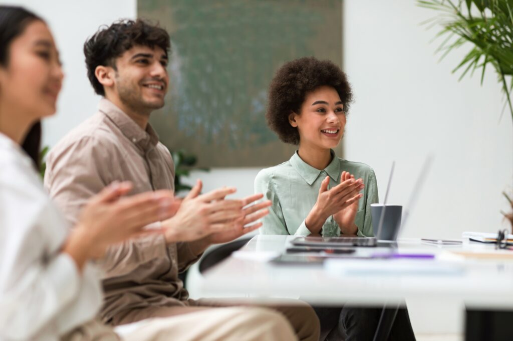 Colleagues Expressing Joy Over Business Achievement With Applause in Office