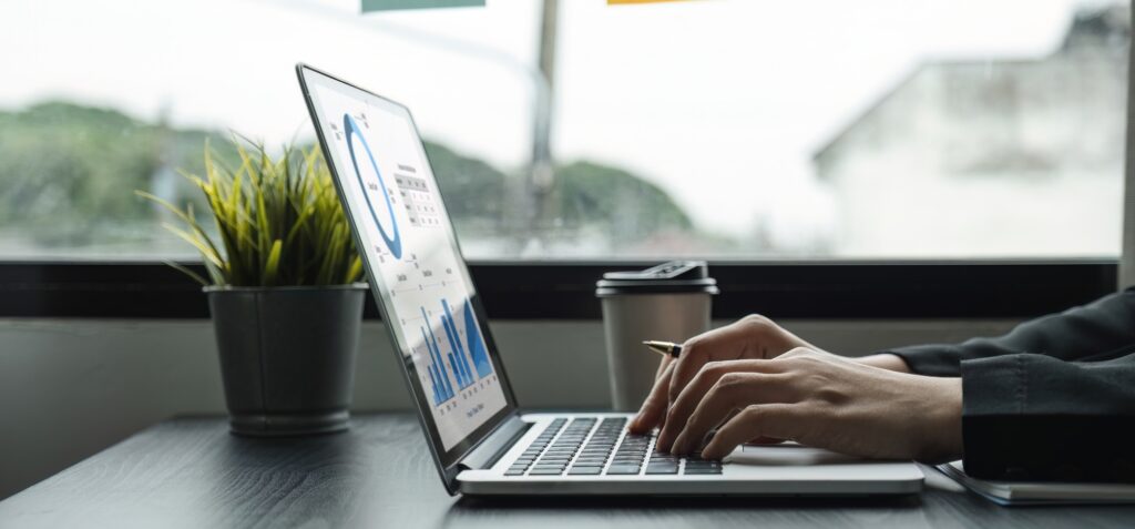 Young businesswoman works on charts and graphs showing organizational results.